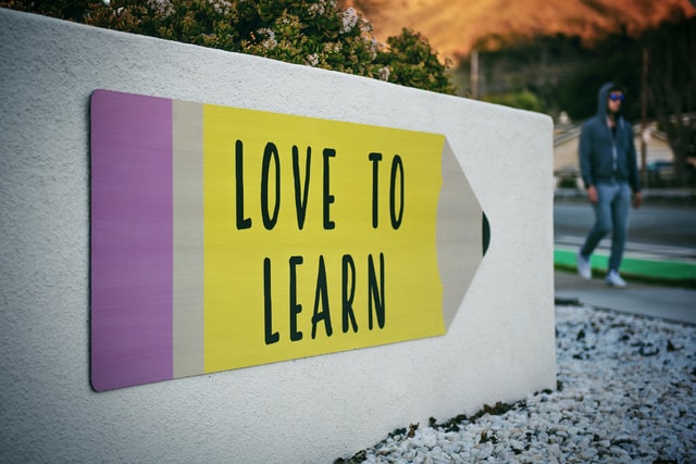 "LOVE TO LEARN" pencil signage on wall